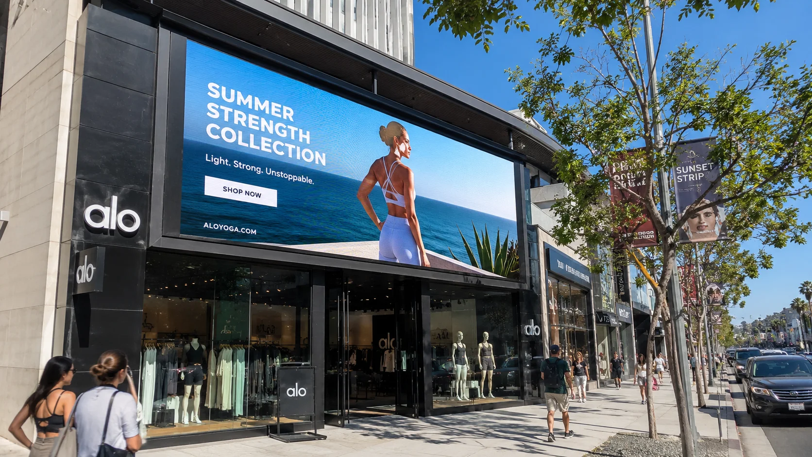 Outdoor LED display installed on a retail storefront with bright daylight visible content