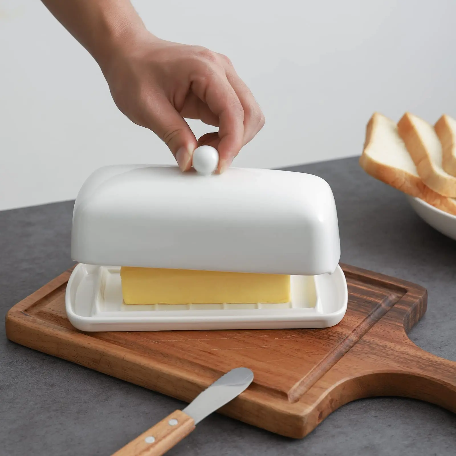 Nucookery White Porcelain Butter Dish with Clean Table Design Raised Non-Slip Ceramic Plate with Lid for Countertop Use