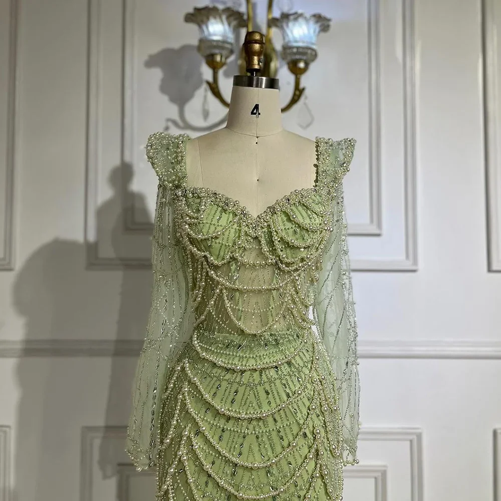 green dress with pearls an evening in New York calls for our Emerald Green gown and pearl drop earrings a pairing as iconic as the skyline itself! #LucianaEmilia