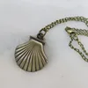 Montre collier coquillage en bronze antique