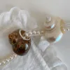 Brown-green antique-style napkin ring with snail motif
