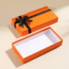 Orange-themed gift box with bow and lid