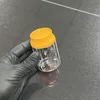 Botella transparente con tapa naranja