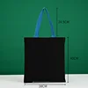 Bolso tote azul de 38x40 cm con asa de lona negra.