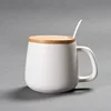 White ceramic mug with lid and spoon
