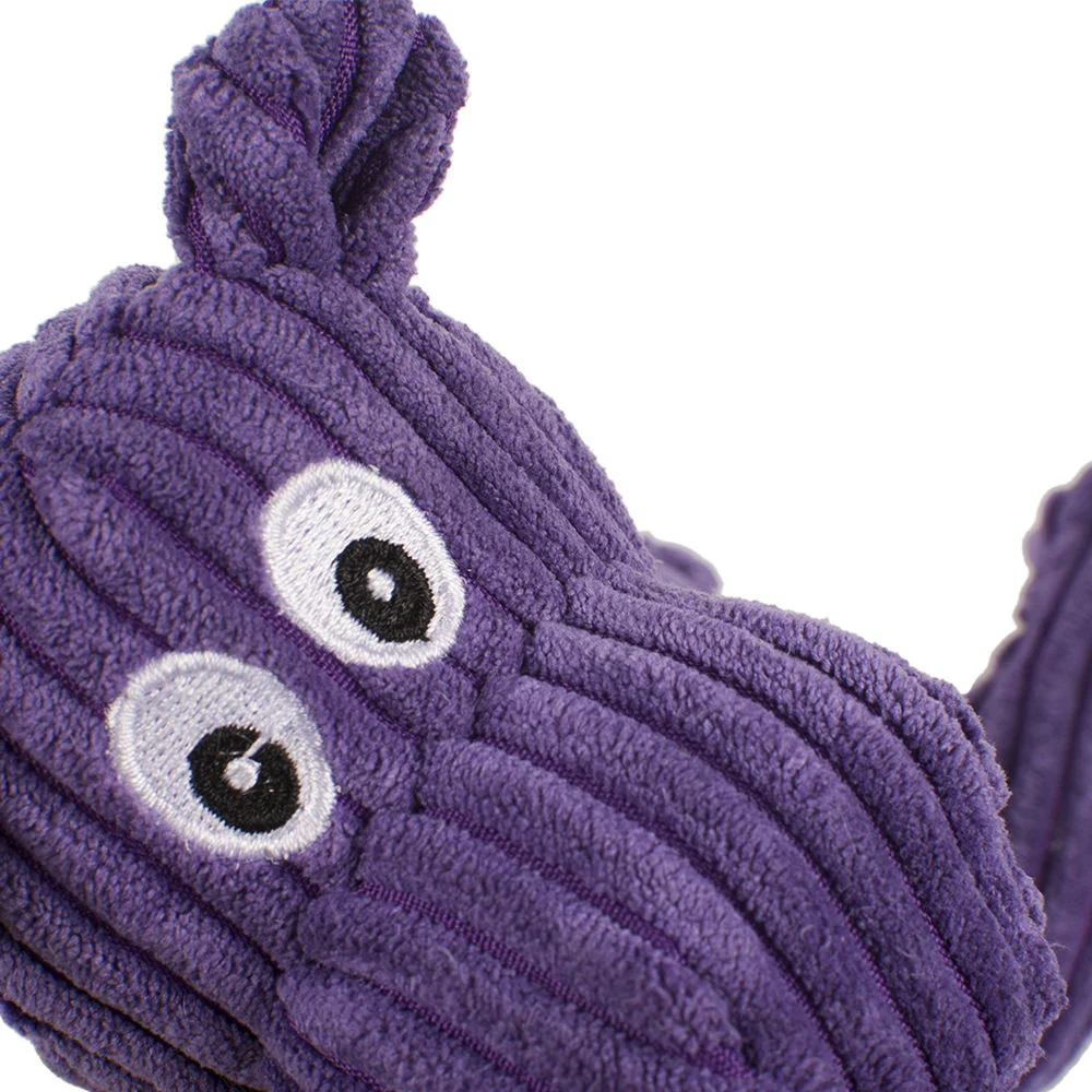 Dog playing with soft plush chew toy