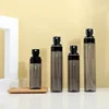 Semi-transparent black bottle + black spray pump