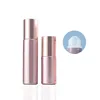 Botella de color sólido oro rosa con tapa brillante y cuentas de vidrio.
