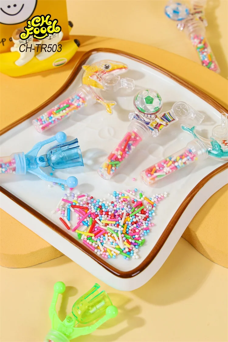 Low MOQ Small Plastic Dolphin and Football Whistle Shaking Needle Toys with Colorful Candy for Kids