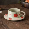 Apple-shaped clay cups and saucers