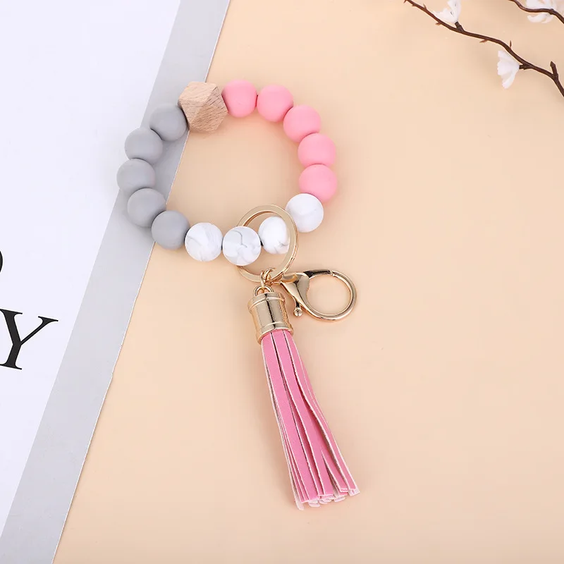 Bracelet élastique en perles de silicone personnalisées porte-clés en cuir  avec pompon Bracelet en perles de silicone porte-clés de bracelet