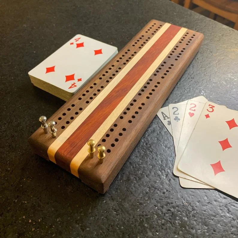 woodnb wooden cribbage board game with metal pegs and a standard