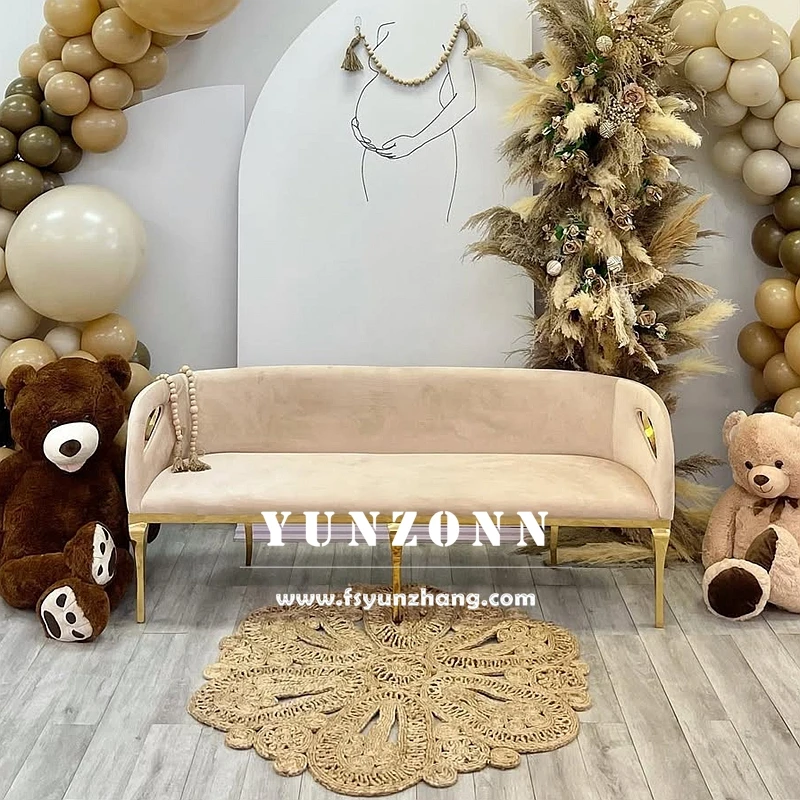 Velvet upholstered bridal couch with gold stainless steel base - angled view