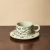 Cat-shaped clay cups and saucers