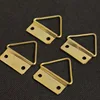 Two large gold-plated triangular hooks [with screws]