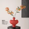 Textured vase with red flame lilies and orange 2 stems