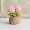 Bolsa de la suerte con rosas rosadas de doble flor.