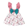 Vestido de niña con estampado de mariposas y magnolias, lazo turquesa en el hombro y color rosa