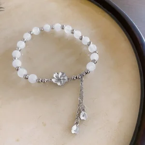 Elegant White Beaded Bracelet with Silver Flower Petal Tassel Charm Fashionable Women's Jewelry Perfect for Daily Wear Gifting