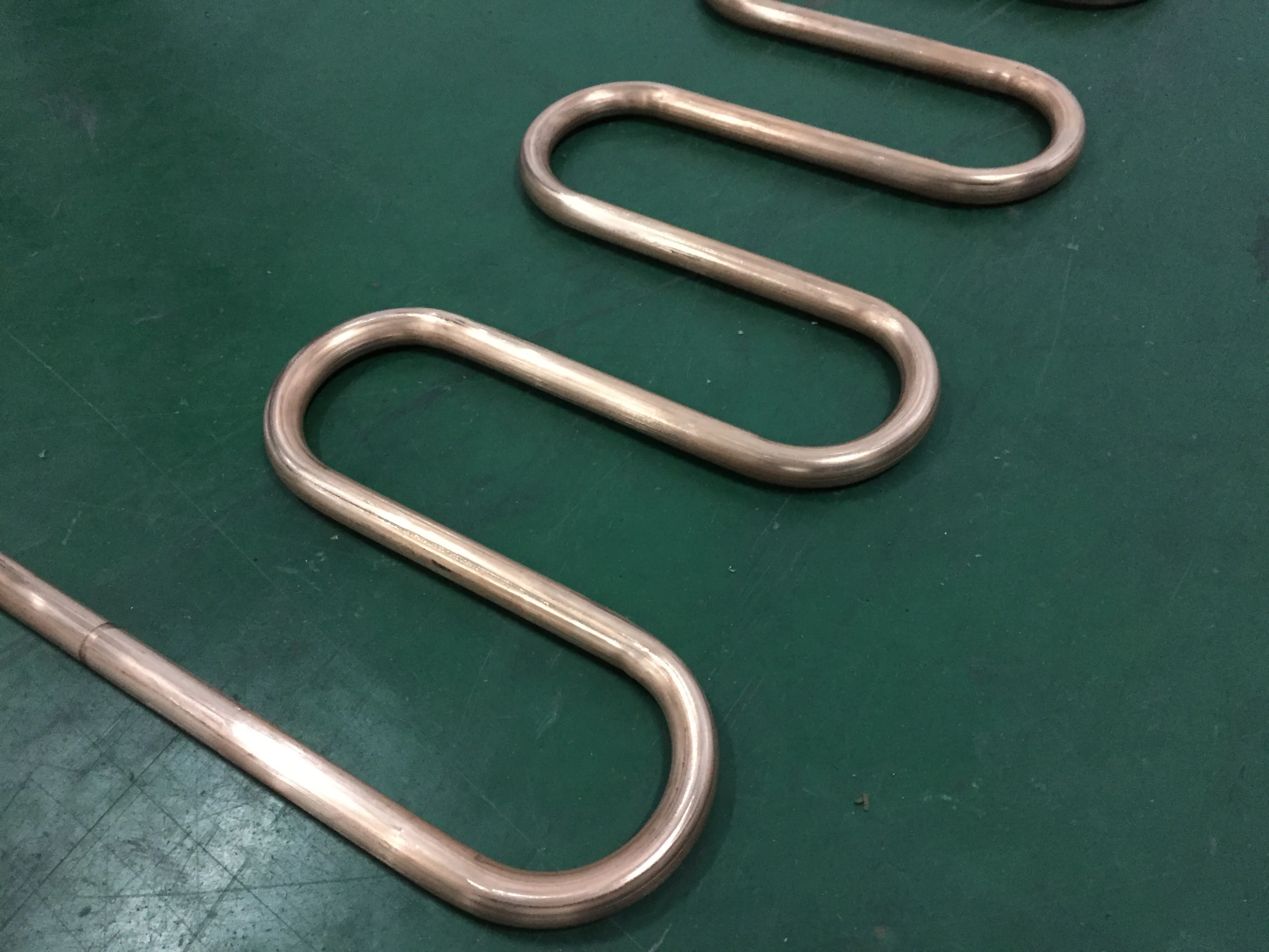 BOBO Machine automatic pipe tube straightening bending serpentine and cutting shown in a detail photo for this news article
