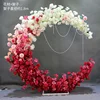 Puerta de luna con degradado rosa, estante con ruedas y flor incluida.