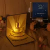 Colored cake, blue music, lighting, included envelope