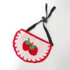 White strawberry-patterned bib with ties