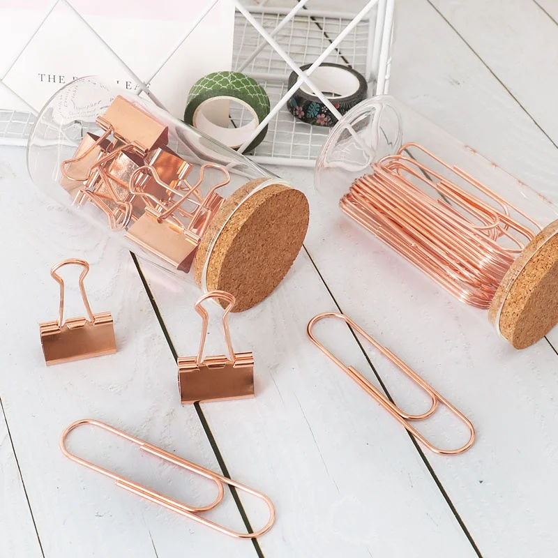 office rose gold paper clips and binder clips in glass jar