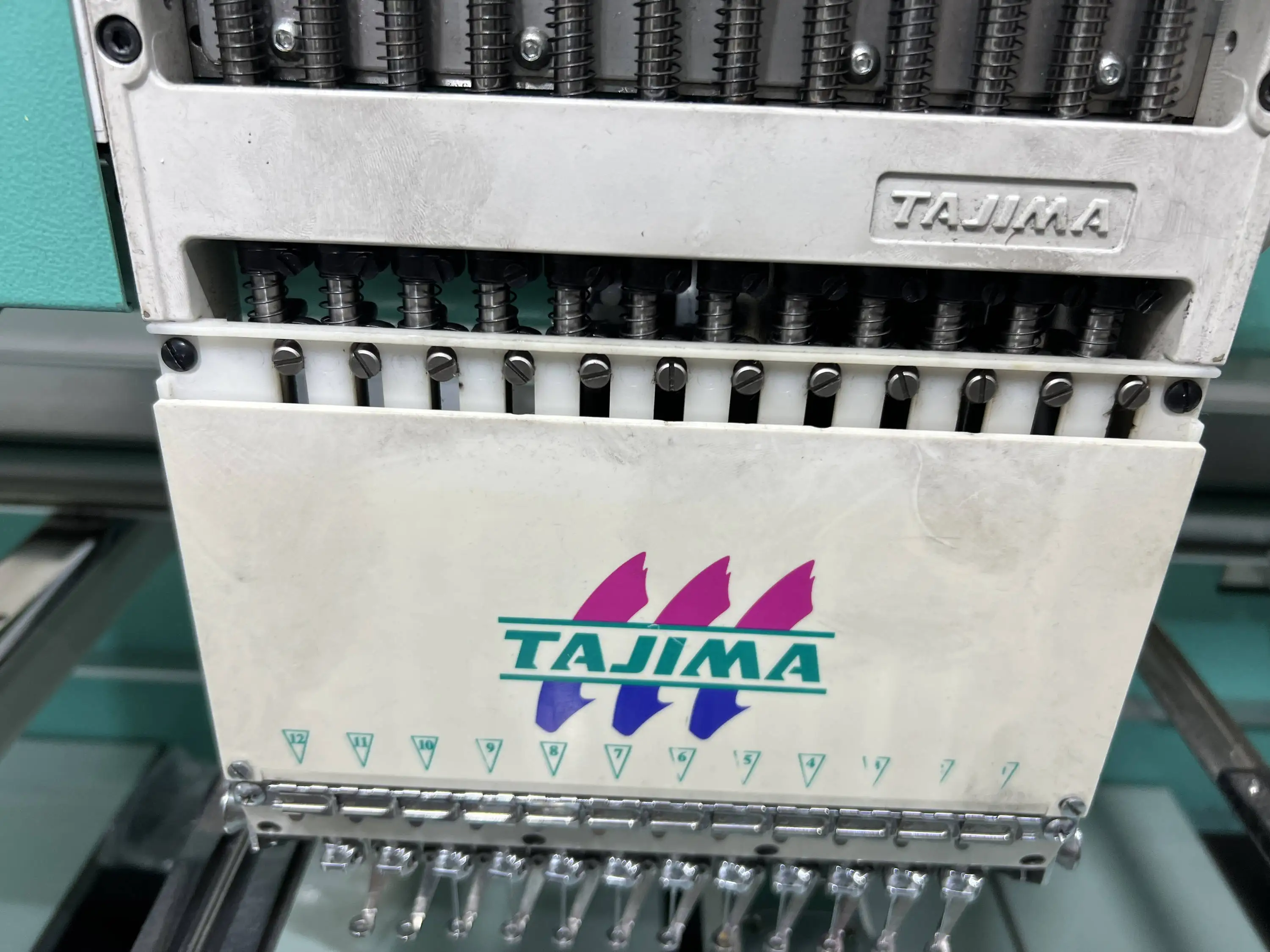 Tajima Embroidery Machines with a Backdrop of Isacord Thread