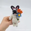 Dog holding flowers
