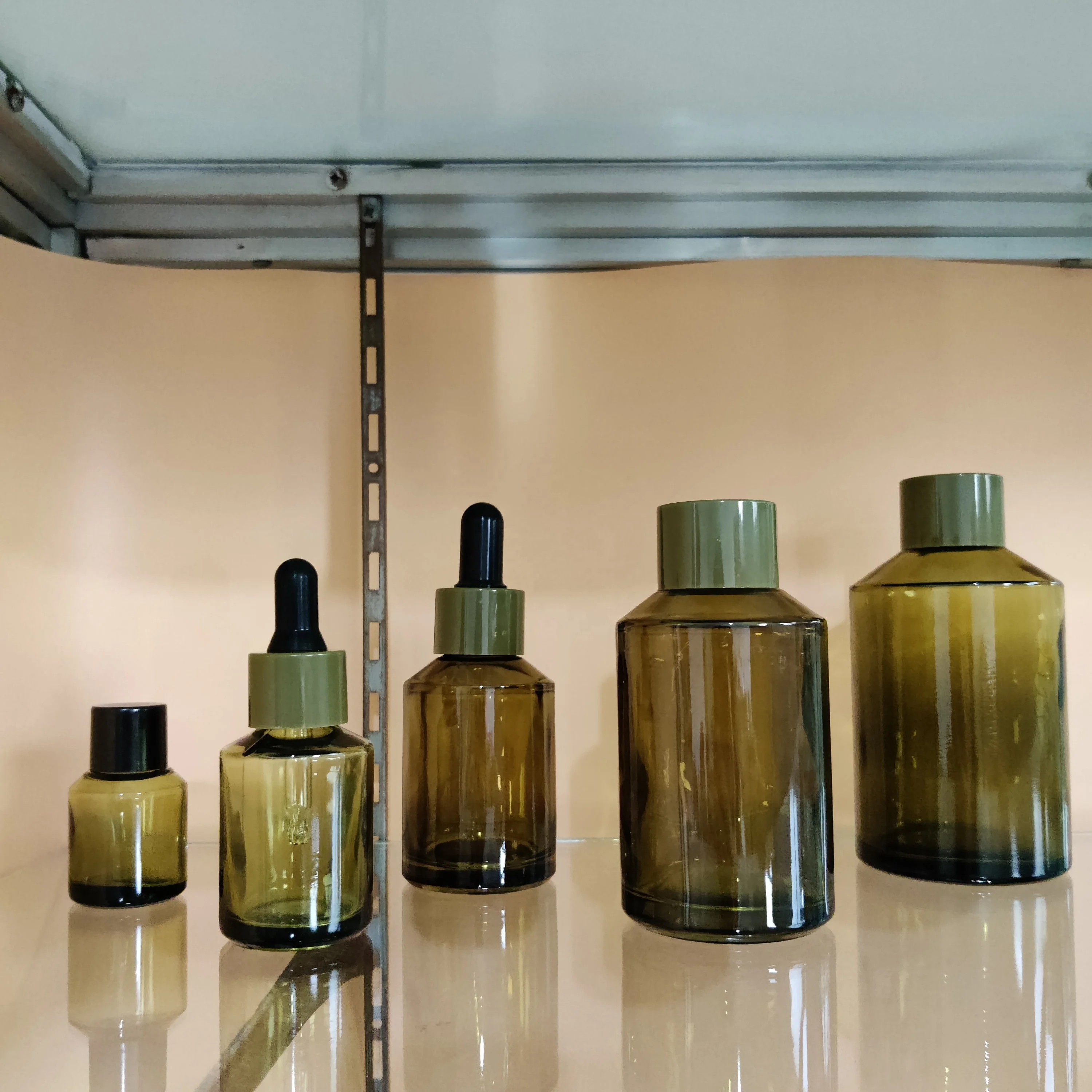 Factory hot sell cosmetic olive green slant shoulder glass lotion bottle with back pump and dropper