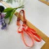 สายสะพายไหล่ลายจุดสีส้ม-เขียว