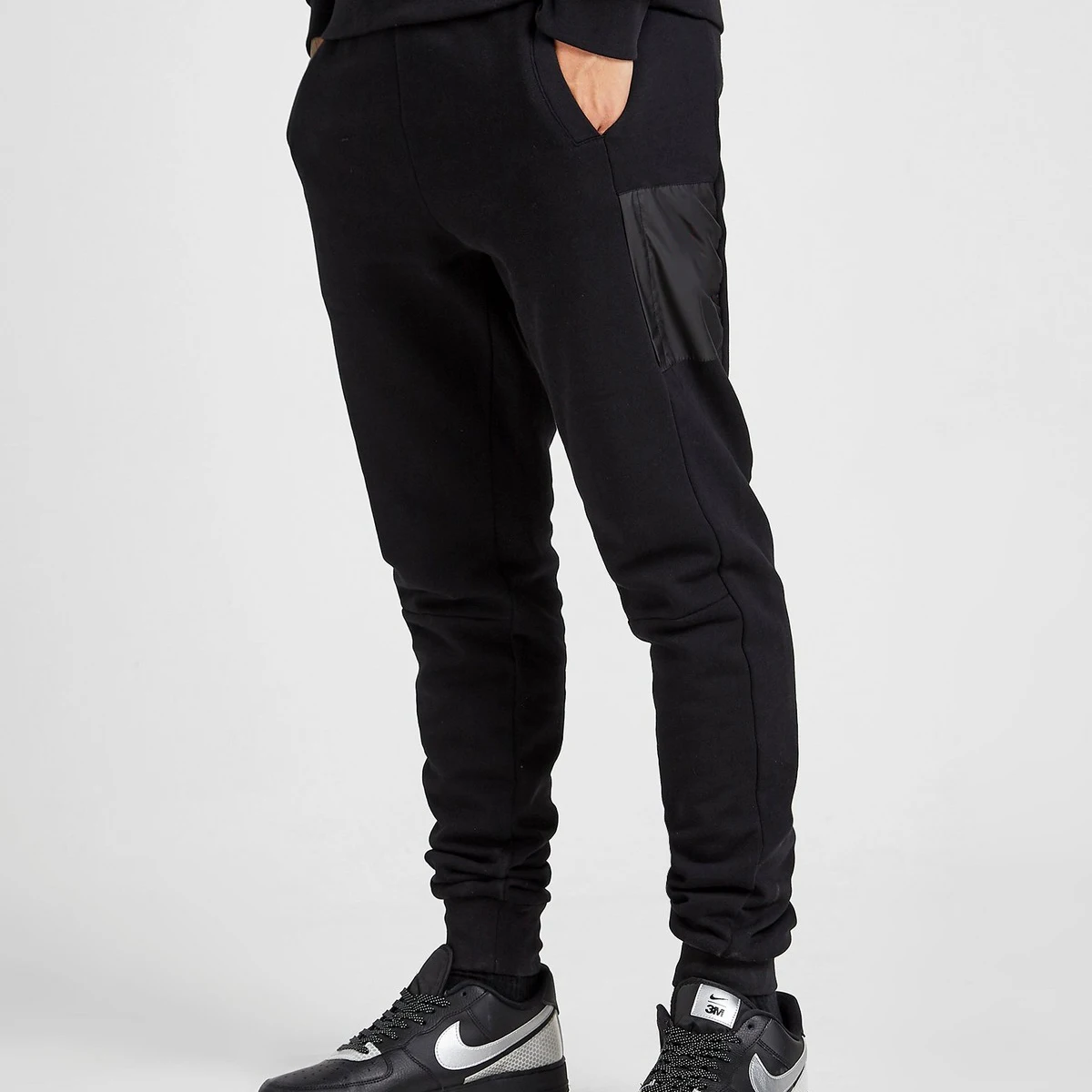 nike repeat pack logo taping cuffed joggers in black