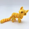 Gato dorado de 12 cm de largo.