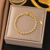 Bracelet chaîne à billes doré - 12 maillons
