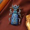 colorful Egyptian scarab brooch in blue