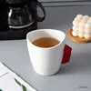 White cup with red handle