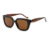 C2 bright black frame with striped legsdark brown lenses