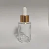 clear bottle + shiny gold aluminum ring + white rubber head
