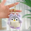Pingüino travesti morado + hebilla dorada