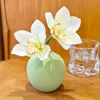 Two small white and green ceramic bottles