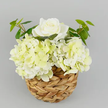 White artificial roses and yellow small flowers in a braided pot Plastic silk simulation flower
