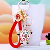 Tortue colorée + ficelle porte-bonheur rouge