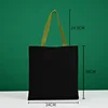 Bolso tote verde de 34*38 con asa de lona negra.