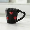 Red heart with black handle
