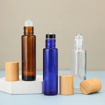 Custom Empty cosmetics essential oil perfume 4ml 5ml 8ml 10ml clear amber blue glass roll on bottle with plastic bamboo lids