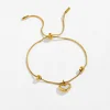 xkb0174-bracciale bianco con cuore in oro