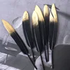 Coltello nero con testa dorata a spruzzo
