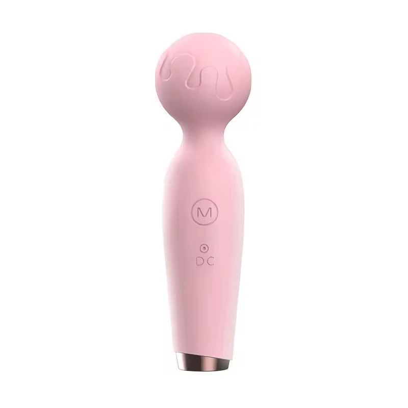Mini vibrator next to USB charging cable for scale