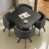 Black square table with four cloth chairs